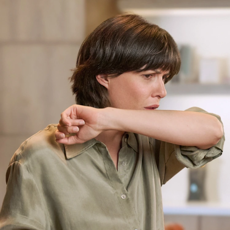 Kobieta kaszle w łokieć jadąc do pracy autobusem